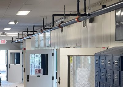 Completed piping for water flow to sprinklers in hallway, classrooms, and labs.